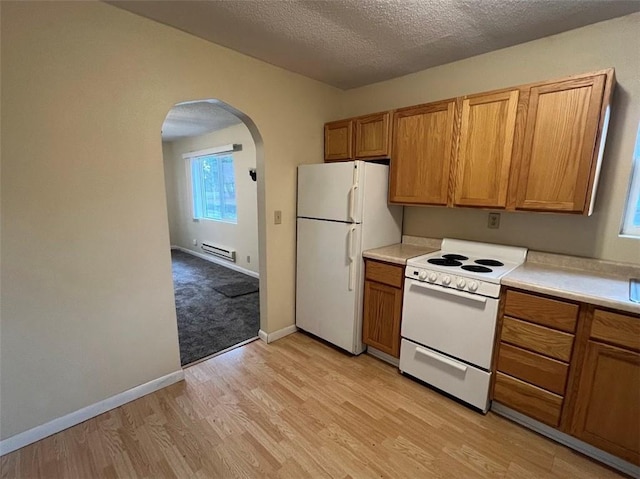 kitchen featuring baseboard heating, light wood-type flooring, a textured ceiling, and white appliances