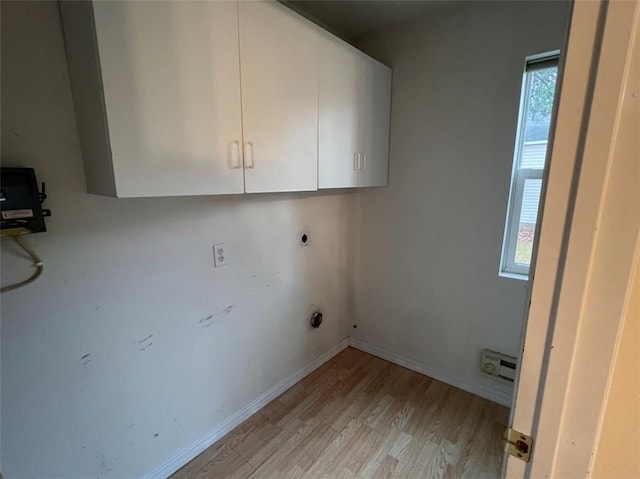 washroom featuring cabinets, light hardwood / wood-style floors, and hookup for an electric dryer