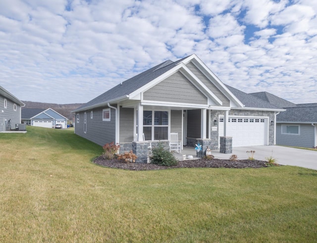 craftsman inspired home featuring a front lawn, a garage, and covered porch