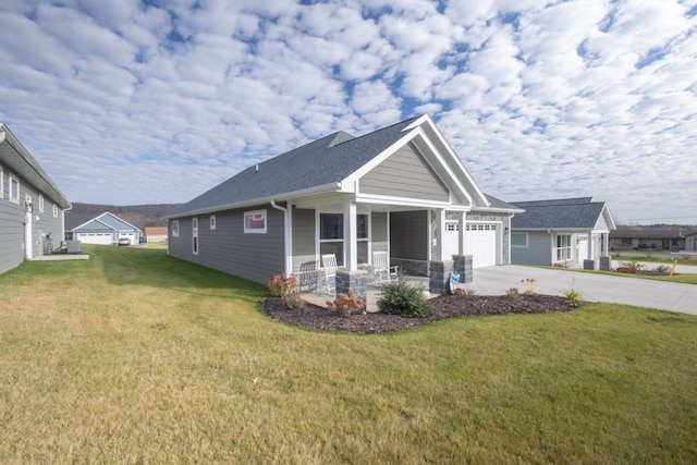 view of front of house with a garage, a front lawn, and covered porch