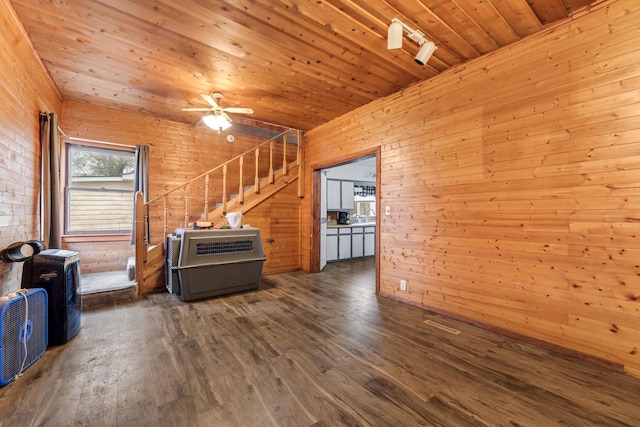 living room with wooden ceiling, dark hardwood / wood-style floors, wood walls, and ceiling fan