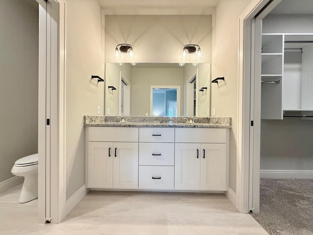 bathroom with toilet and vanity