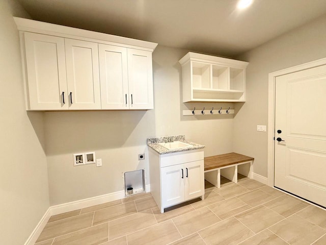 washroom with cabinets, washer hookup, and hookup for an electric dryer