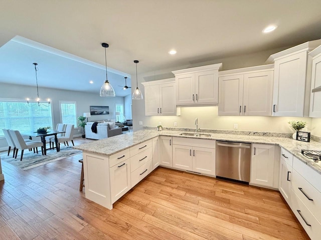 kitchen featuring kitchen peninsula, white cabinets, decorative light fixtures, and dishwasher