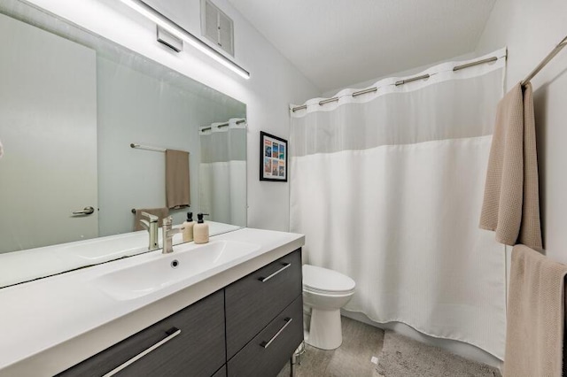 bathroom featuring toilet, a shower with curtain, and vanity