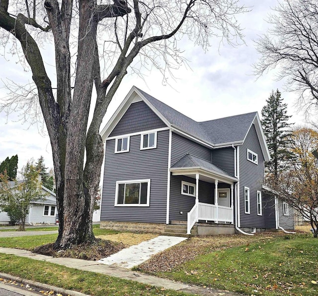 front of property with a front yard and covered porch