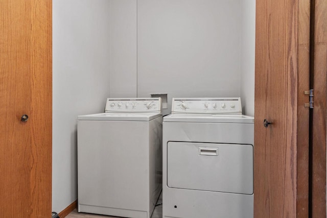 clothes washing area featuring separate washer and dryer