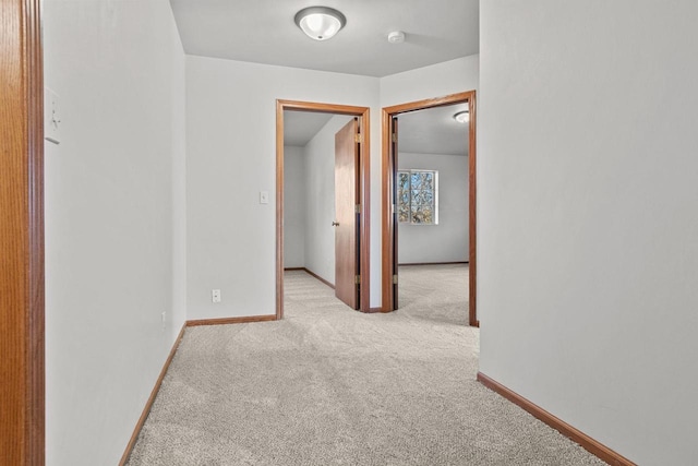 hallway featuring light carpet