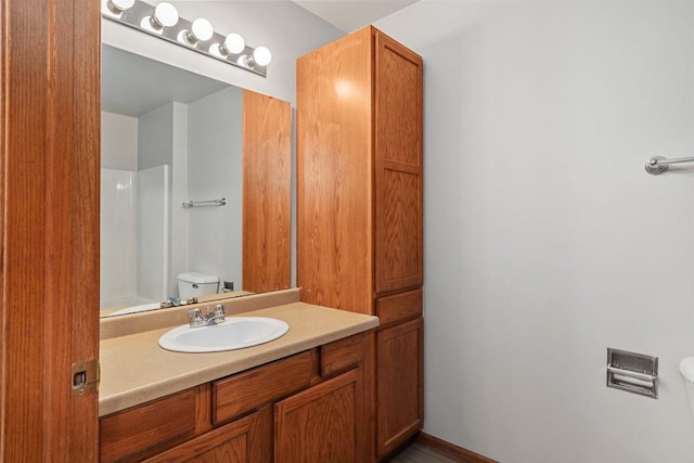 bathroom featuring vanity and toilet