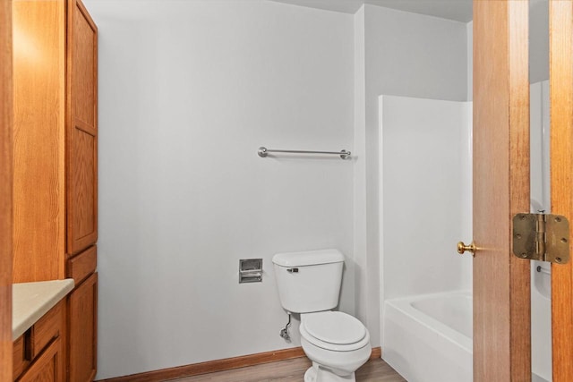 bathroom featuring vanity, hardwood / wood-style flooring, and toilet