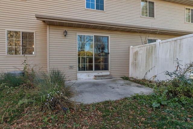 view of exterior entry featuring a patio area