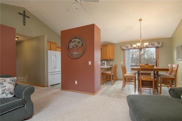 dining room featuring ceiling fan with notable chandelier, lofted ceiling, and light carpet