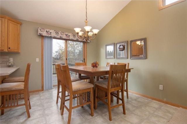 dining space with a chandelier, plenty of natural light, and high vaulted ceiling