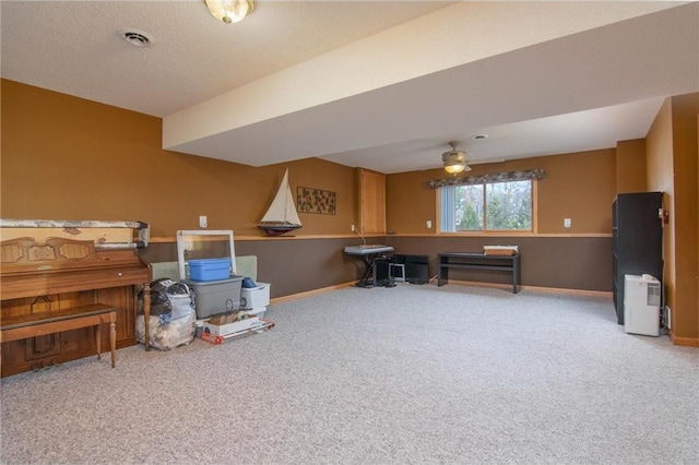 miscellaneous room featuring a textured ceiling, carpet, and ceiling fan