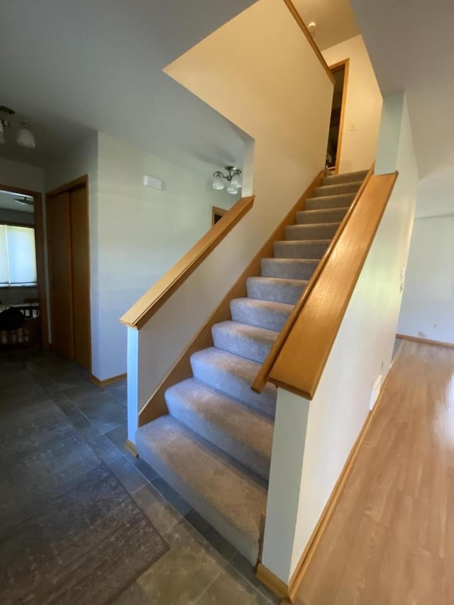 stairway with hardwood / wood-style flooring