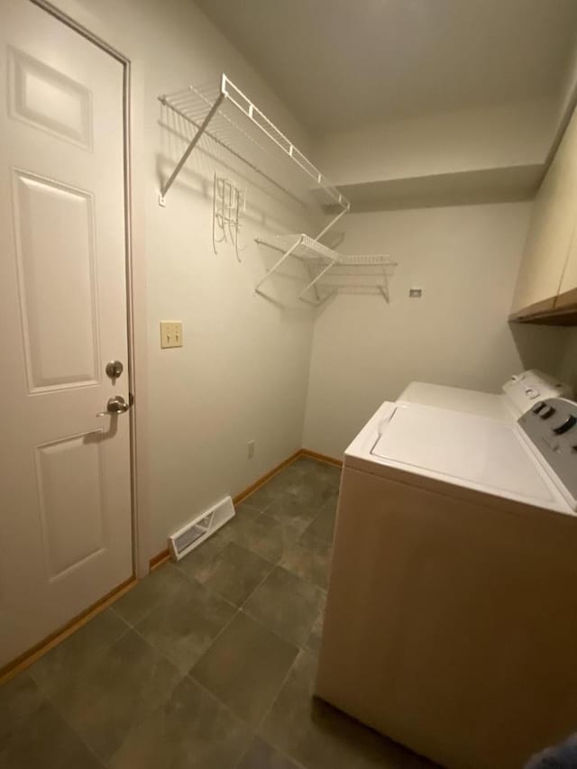 laundry area featuring cabinets and washer and dryer