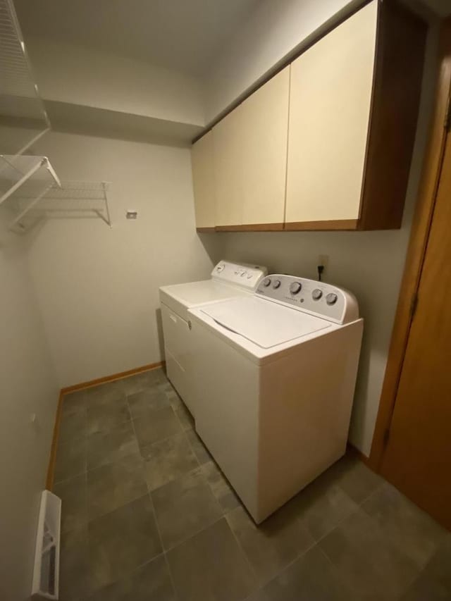 laundry room featuring tile patterned flooring, washing machine and dryer, and cabinets