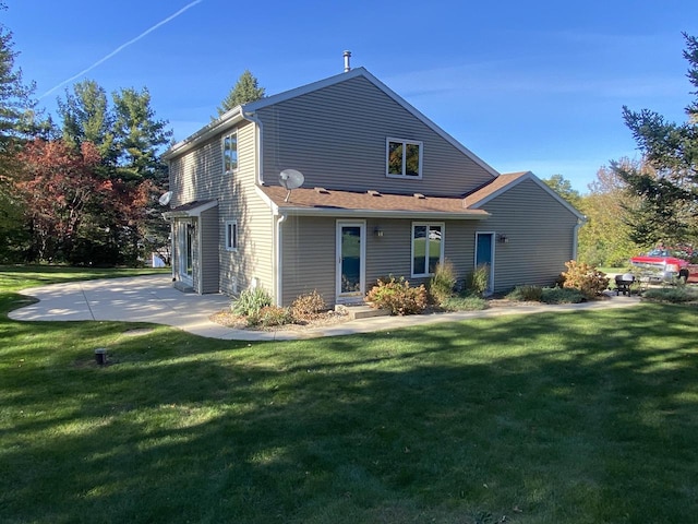 rear view of property with a lawn