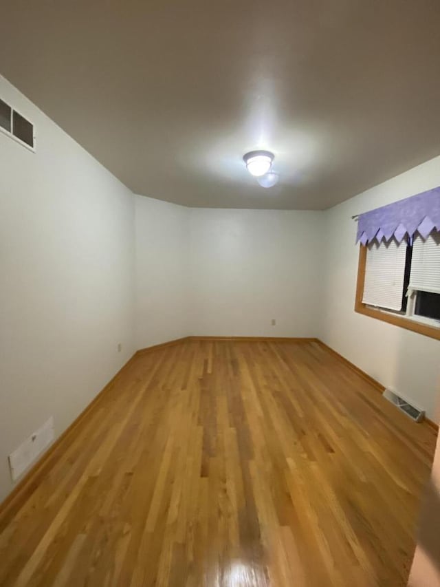 spare room featuring hardwood / wood-style floors