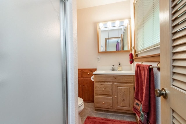 bathroom with tile patterned flooring, vanity, and toilet