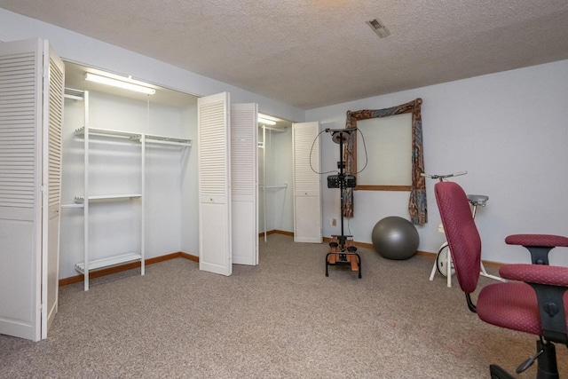 interior space featuring a textured ceiling and carpet