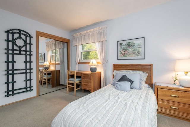 bedroom featuring light colored carpet and a closet