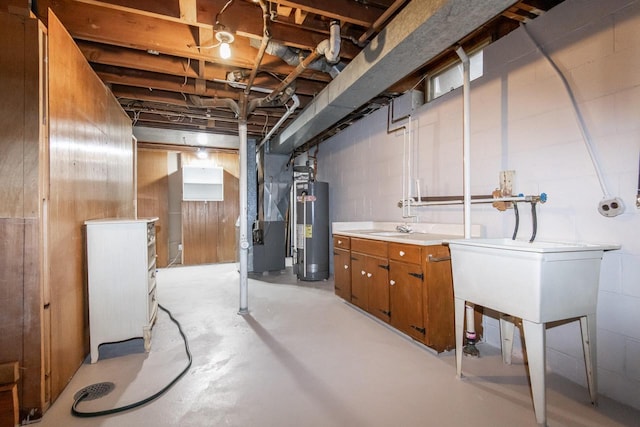 basement featuring water heater, heating unit, and sink