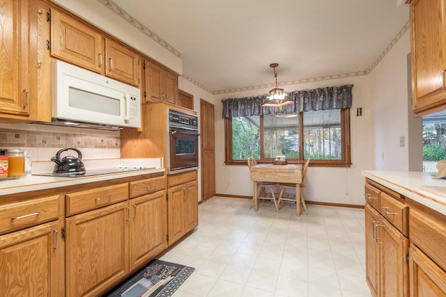 kitchen with hanging light fixtures, black oven, stovetop, and backsplash