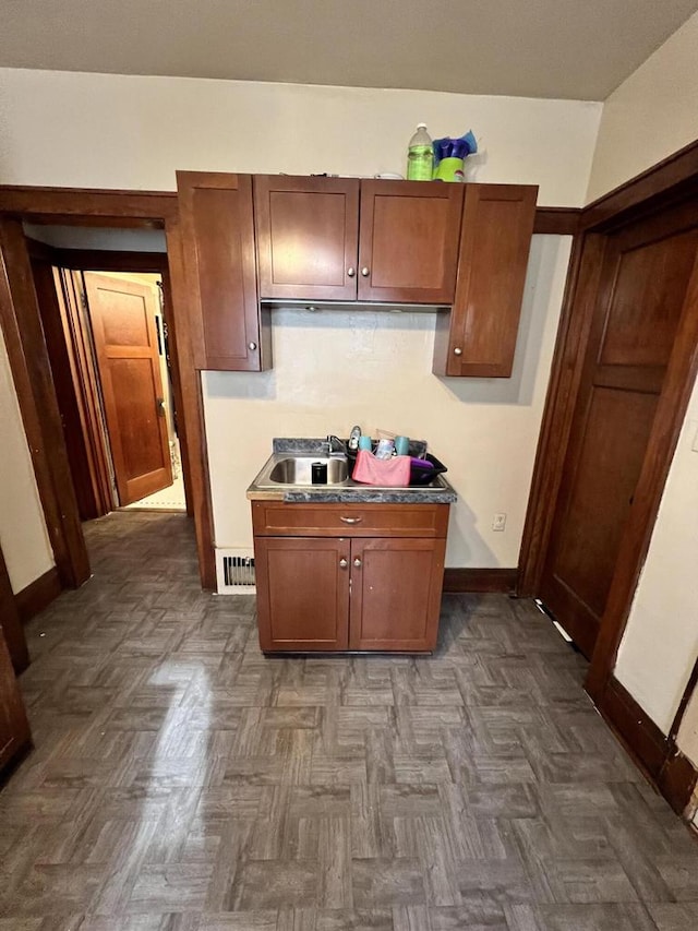 kitchen featuring sink and dark parquet floors