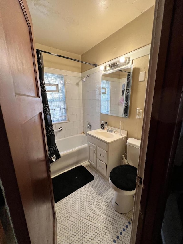 full bathroom with vanity, toilet, and shower / tub combo