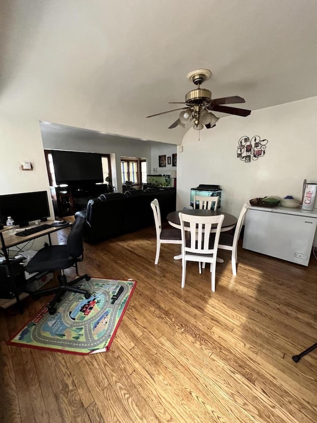 dining area with wood-type flooring and ceiling fan