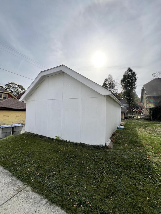 view of side of home with a yard