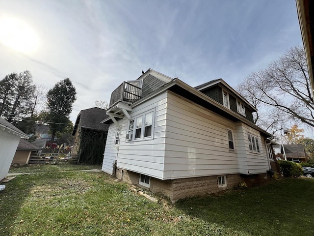 view of property exterior featuring a lawn and a balcony