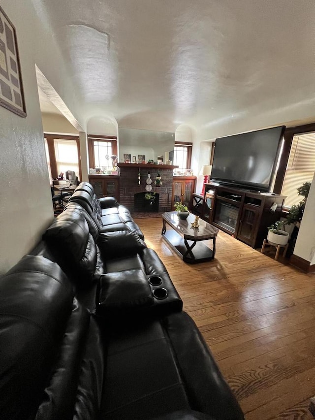 living room with a fireplace and hardwood / wood-style floors