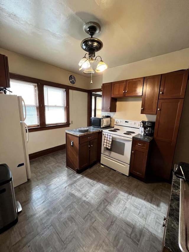 kitchen featuring white appliances and kitchen peninsula