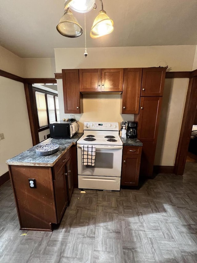 kitchen with hanging light fixtures, light stone counters, and electric stove