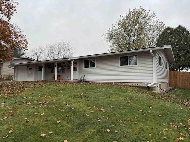 ranch-style house featuring a garage and a front yard