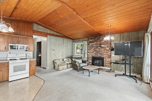 W11384 Bay Dr, Lodi, WI 53555 - living room with a chandelier, wooden ceiling, vaulted ceiling, wood walls, and a brick fireplace