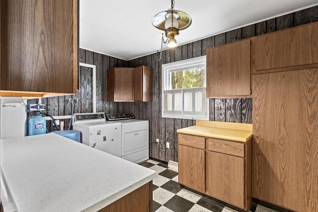 W11384 Bay Dr, Lodi, WI 53555 - kitchen featuring washing machine and clothes dryer, light floors, light countertops, and wood walls
