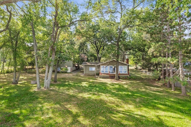 view of yard with a storage shed and a wooden deck