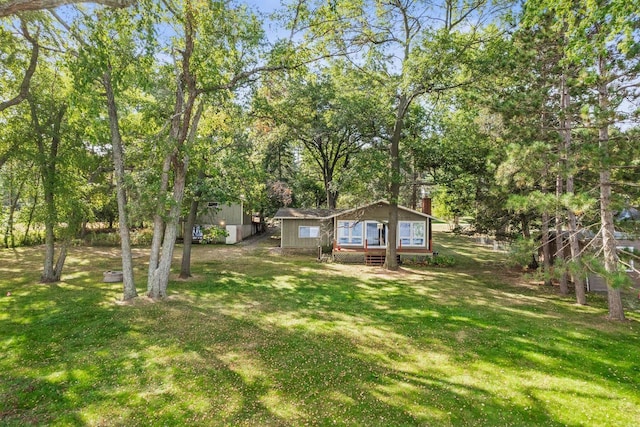 W11384 Bay Dr, Lodi, WI 53555 - view of grassy yard featuring an outdoor structure and view of wooded area