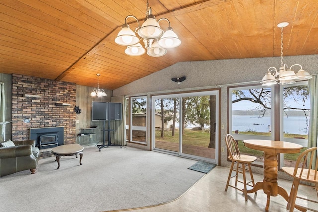 W11384 Bay Dr, Lodi, WI 53555 - sunroom with a chandelier, lofted ceiling, healthy amount of natural light, and a wood stove