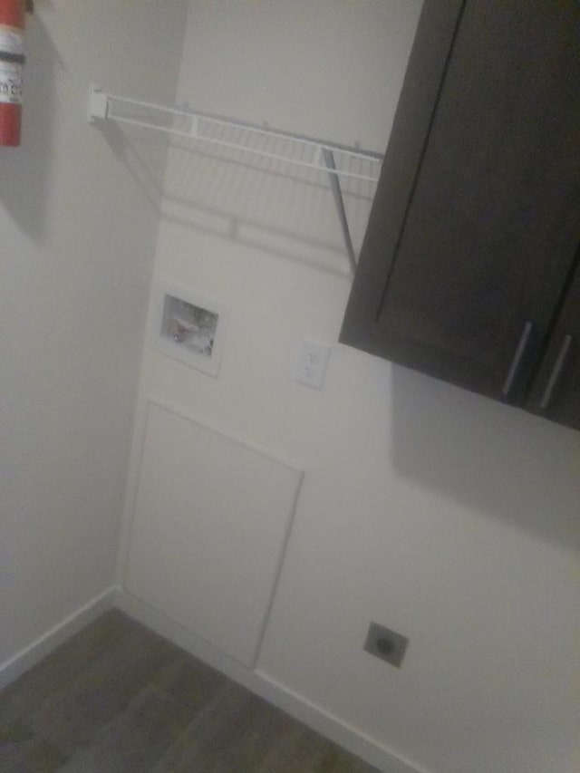 laundry room with hookup for a washing machine, dark wood-type flooring, and hookup for an electric dryer