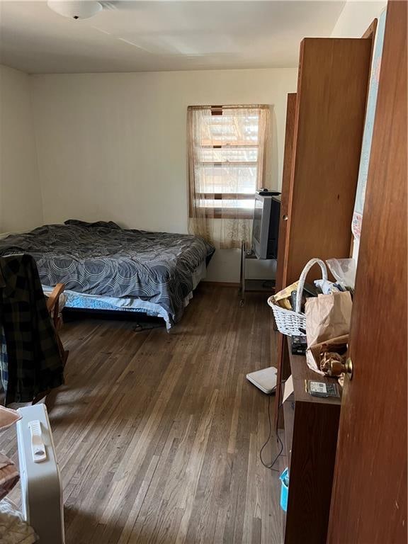 bedroom with dark wood-type flooring