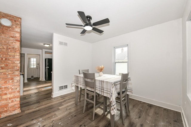 dining space with ceiling fan, a healthy amount of sunlight, and dark hardwood / wood-style flooring