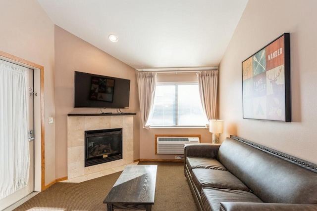 carpeted living room featuring a tiled fireplace, lofted ceiling, and an AC wall unit