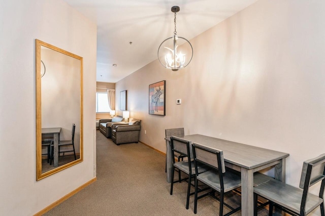 carpeted dining area featuring a notable chandelier