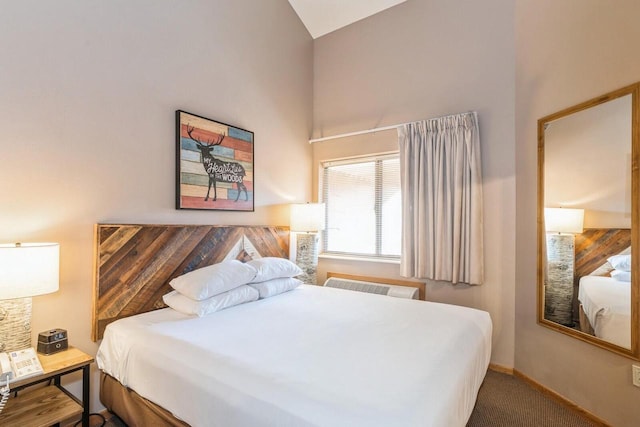 bedroom with high vaulted ceiling and carpet