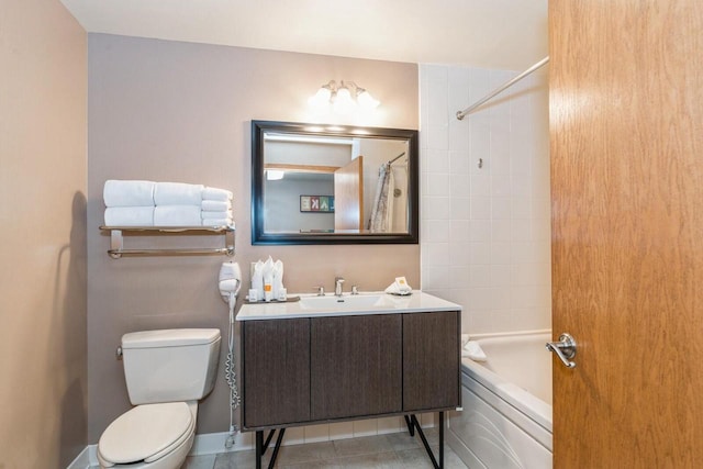 full bathroom with toilet, vanity, tiled shower / bath, and tile patterned flooring