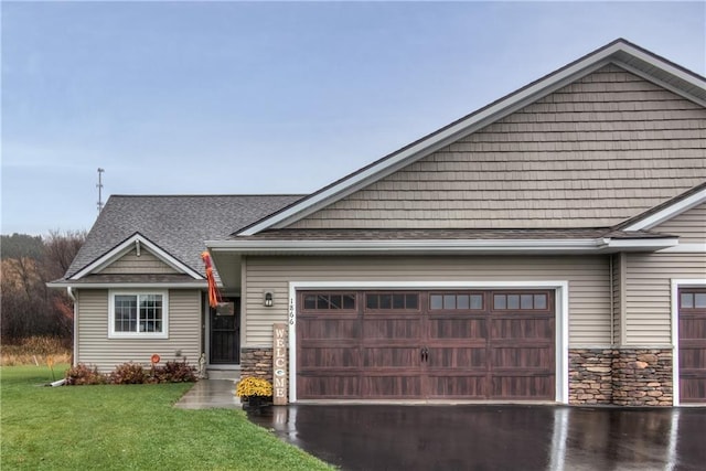 view of front of house with a garage and a front lawn